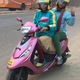 A passenger on a Bikxie Pink bike.